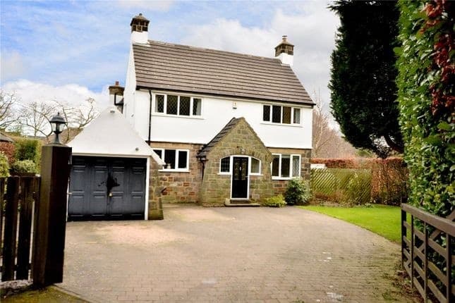 Front of the house before the work, with the white-rendered garage and its grey double doors
