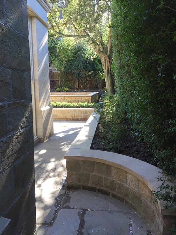 Curved stone garden wall beside the path to the rear garden, Park Avenue, Harrogate