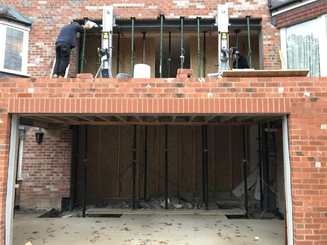 Props holding the new steels as the first floor goes up over a wide opening